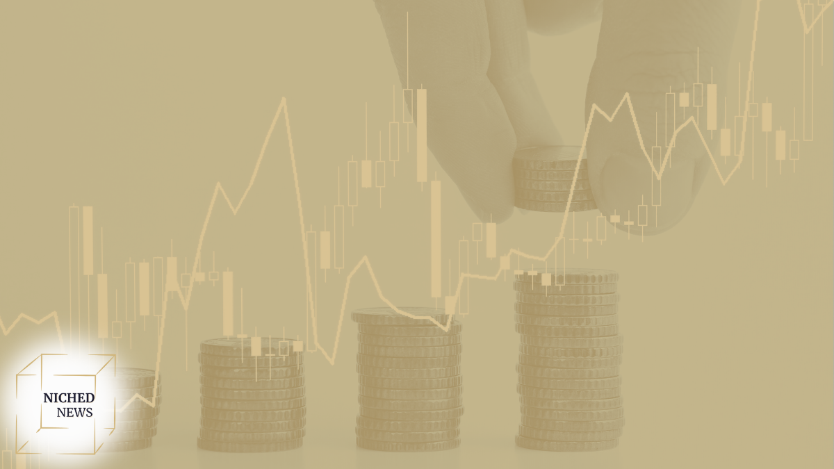 Hand stacking coins with financial chart overlay