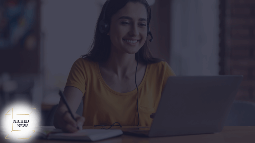 Woman smiling with headset taking notes during online lesson